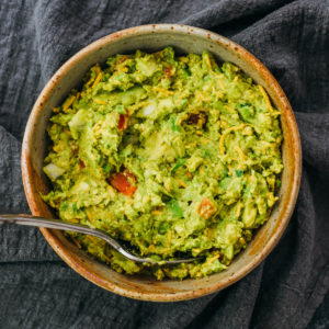 overhead view of guacamole served in stoneware bowl