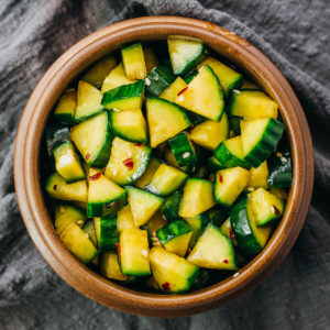 asian cucumber salad served in wooden bowl