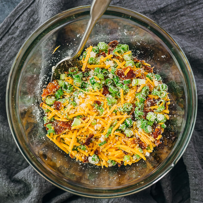 stirring stuffing ingredients in glass mixing bowl