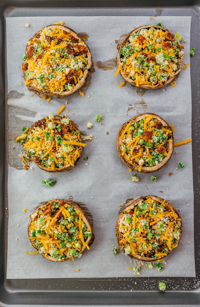 stuffed portobello mushrooms on baking sheet