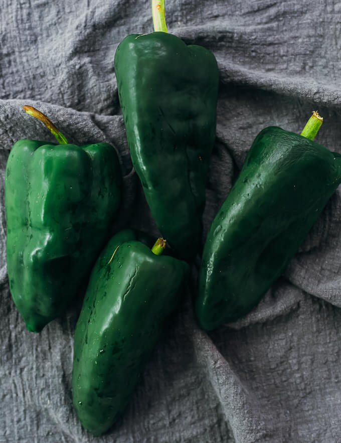 four raw poblano peppers