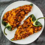 stuffed poblano peppers served on white plate