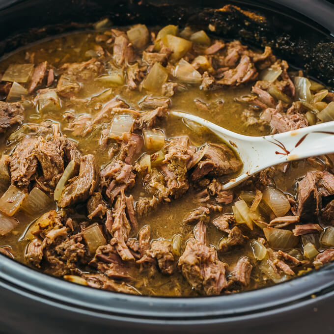 ladling up some shredded lamb stew