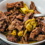 close up view of pot roast with peppers