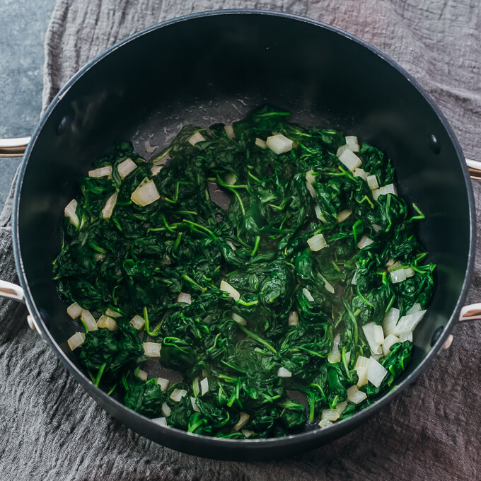 wilted spinach and onions in pot