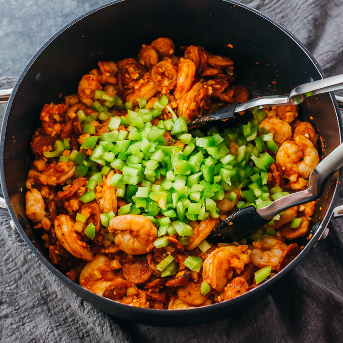 adding bell pepper to jambalaya