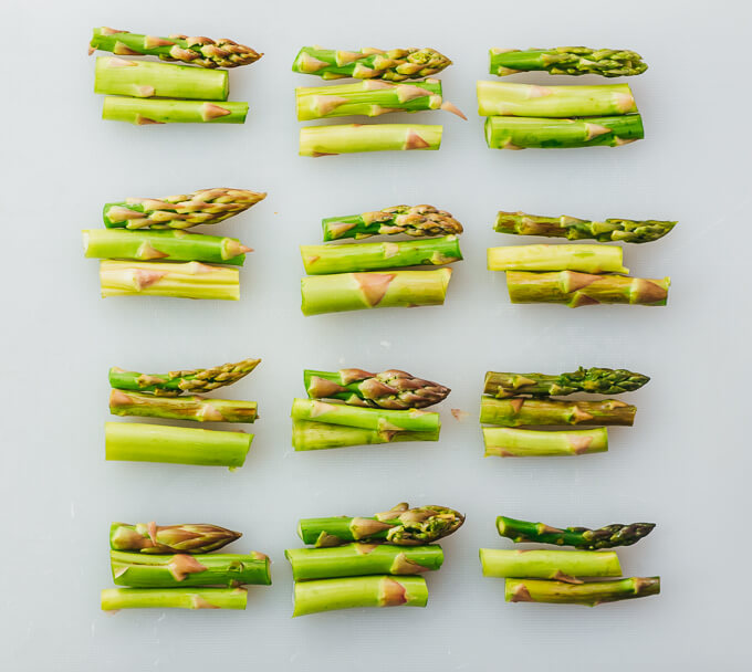 bundles of asparagus on cutting board