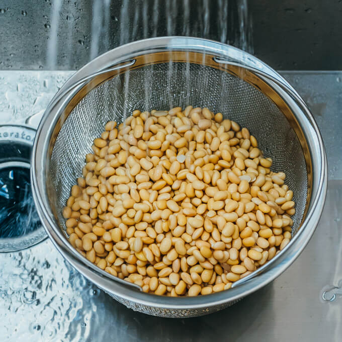 rinsing soybeans in a colander